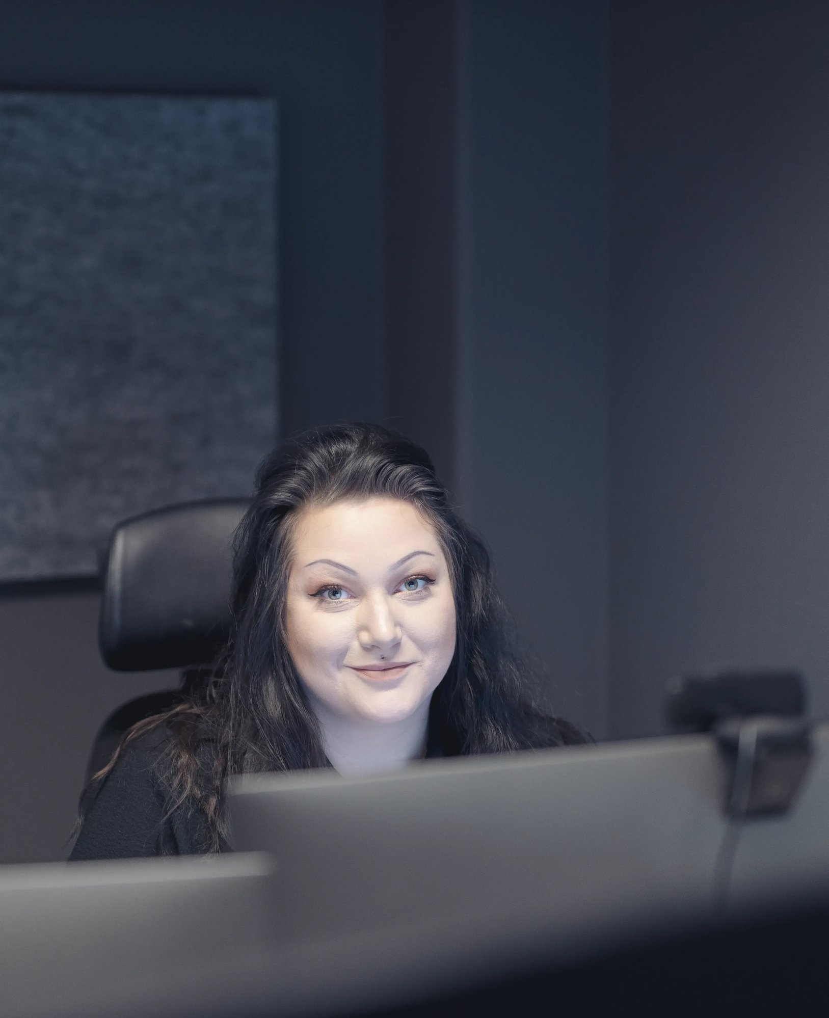 A woman sitting in front of her computer screen