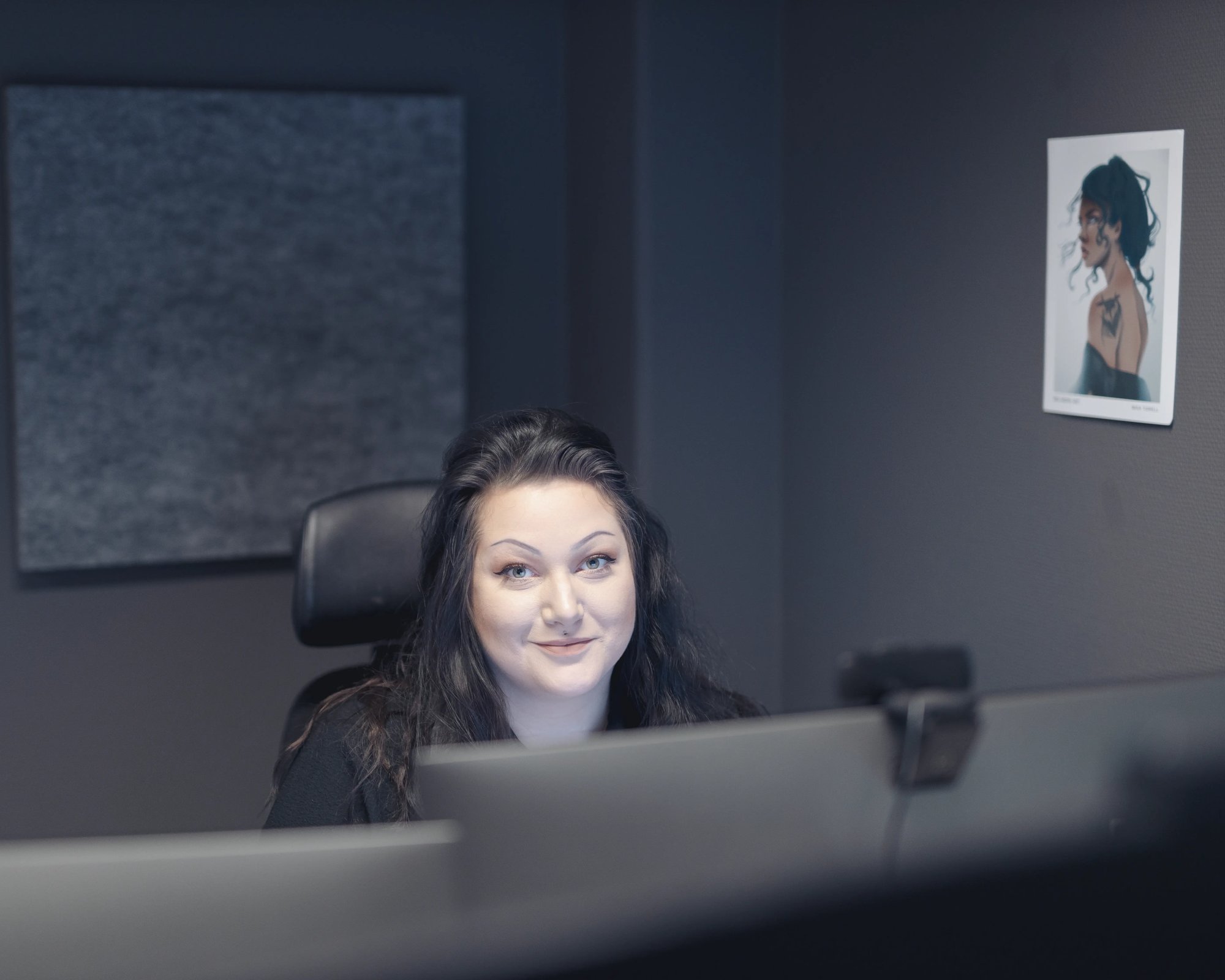 Josefine working at the TeQflo office.She is smiling at the camera.