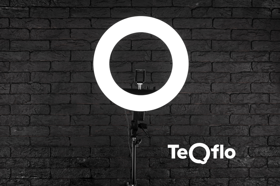 A black brick wall with a ring light glowing.